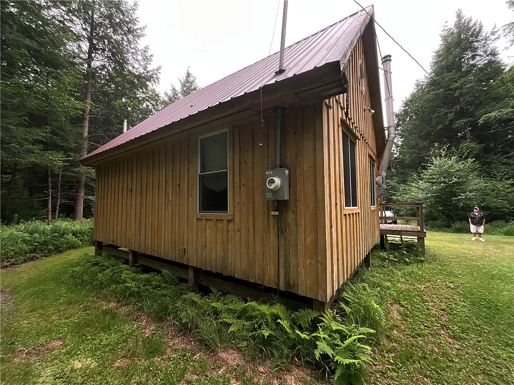 An Adirondack-Style Cabin on 300 Feet of a 35-Acre Pond